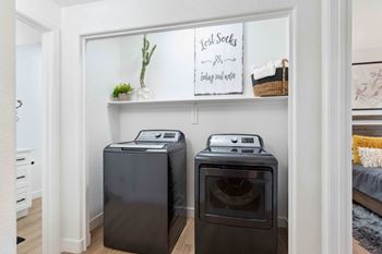 Two black front load washing machines in a laundry room. at The Laurel Apartments, Arizona, 85286